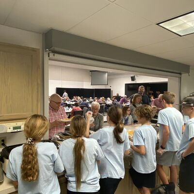 Youth serving scramble meal for the community.